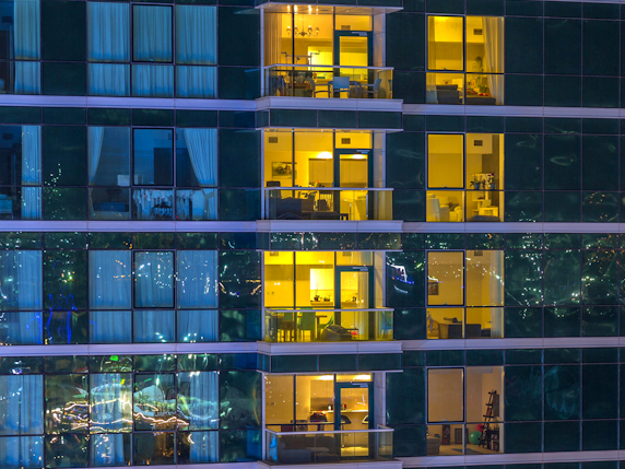 View inside high-rise apartments with open windows
