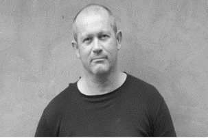 Simon Reece is a ceramic artist. He is wearing a black t-shirt.