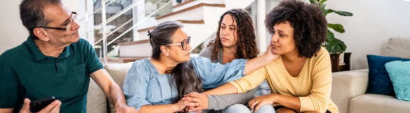 Four people in conversation in a living room